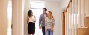 couple and residential leasing agent touring rental property